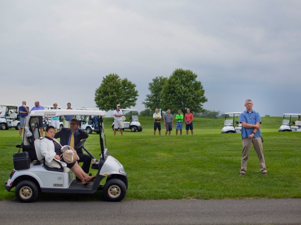 Golf club players join members of the White House Staff and security on the course as they all stop to listen to remarks from President Donald Trump at Trump National Golf Club in Bedminster, N.J., Friday, Aug. 11, 2017. (AP Photo/Pablo Martinez Monsivais)