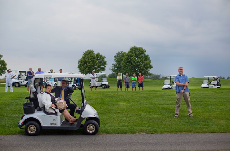 Golf club players join members of the White House Staff and security on the course as they all stop to listen to remarks from President Donald Trump at Trump National Golf Club in Bedminster, N.J., Friday, Aug. 11, 2017. (AP Photo/Pablo Martinez Monsivais)