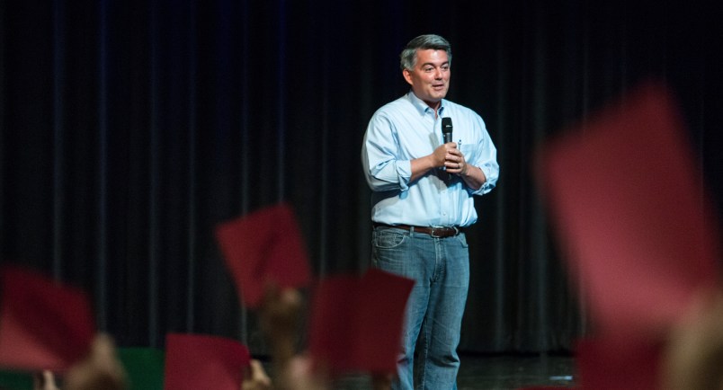 Republican Sen. Cory Gardner of Colorado speaks at a town hall as guests hold red "disagree" and green "agree" cards Tuesday, Aug. 15, 2017, at Pikes Peak Community College in Colorado Springs, Colo.