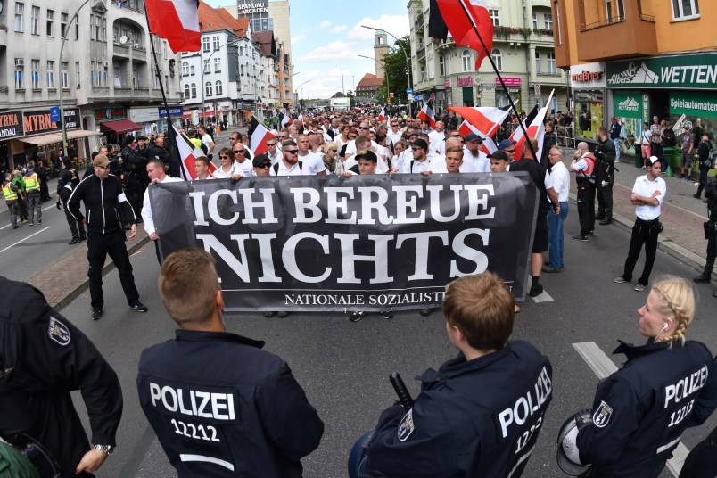 Right-wing extremists walk across the street to commemorate the 30th anniversary of the death of Hitler's deputy Rudolf Hess at the Spandau train station in Berlin, Germany, 19 August 2017. A banner 'Ich bereue Nichts' (lit. I do not regret a thing) can be seen. Hess was convicted as a war criminal and served his sentense at the war criminal prison in Berlin Spandau, where he committed suicide 1987. Four counter demonstrations are also announced. Photo by: Paul Zinken/picture-alliance/dpa/AP Images