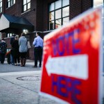 Voter wait in line outside a polling place at the Nativity School on Election Day, Tuesday, Nov. 8, 2016, in Cincinnati. (AP Photo/John Minchillo)