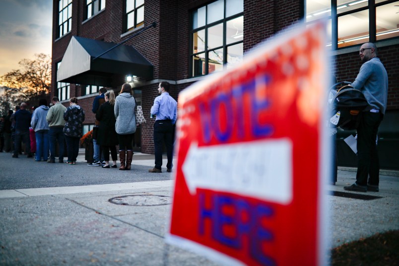 Voter wait in line outside a polling place at the Nativity School on Election Day, Tuesday, Nov. 8, 2016, in Cincinnati. (AP Photo/John Minchillo)