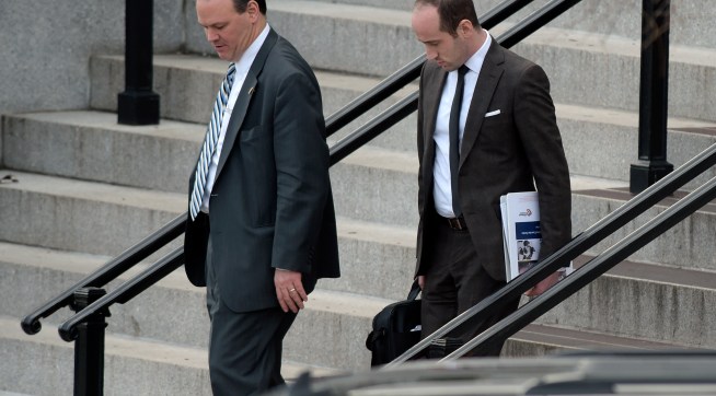 Trump deputy chief of staff for policy, Rick Dearborn, left, and senior policy adviser Stephen Miller, right, walk down the steps of the Eisenhower Executive Office Building on the White House complex in Washington, Friday, Jan. 13, 2017, following a meeting. (AP Photo/Susan Walsh)