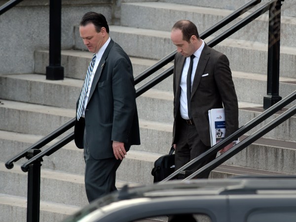 Trump deputy chief of staff for policy, Rick Dearborn, left, and senior policy adviser Stephen Miller, right, walk down the steps of the Eisenhower Executive Office Building on the White House complex in Washington, Friday, Jan. 13, 2017, following a meeting. (AP Photo/Susan Walsh)
