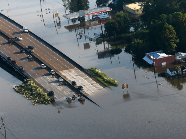 People launch boats into floodwaters from an overpass on Hwy 287 in the aftermath of Tropical Storm Harvey in Kountze, Texas, Thursday, Aug. 31, 2017. (AP Photo/Gerald Herbert)