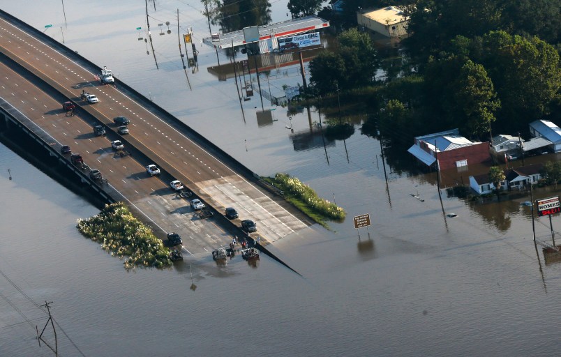 People launch boats into floodwaters from an overpass on Hwy 287 in the aftermath of Tropical Storm Harvey in Kountze, Texas, Thursday, Aug. 31, 2017. (AP Photo/Gerald Herbert)
