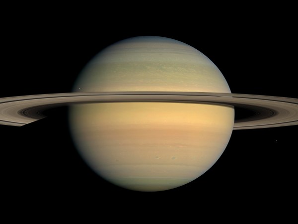 As Saturn advanced in its orbit toward equinox and the sun gradually moved northward on the planet, the motion of Saturn's ring shadows and the changing colors of its atmosphere continued to transform the face of Saturn as seen by Cassini in this image from the mission's fourth year.Cassini has been orbiting Saturn for five Earth years as of June 30, 2009. That's about one sixth of a Saturnian year, enough time for the spacecraft to have observed seasonal changes in the planet, its moons and sunlight's angle on the dramatic rings.This captivating natural color view was created from images collected shortly after Cassini began its extended Equinox Mission in July 2008. The mosaic combines 30 images-10 each of red, green and blue light-taken over the course of approximately two hours as Cassini panned its wide-angle camera across the entire planet and ring system on July 23, 2008, from a southerly elevation of 6 degrees.Six moons complete this constructed panorama (see the full-size image): Titan (3,200 miles, or 5,150 kilometers, across), Janus (111 miles, or 179 kilometers, across), Mimas (396 kilometers, or 246 miles, across), Pandora (81 kilometers, or 50 miles, across), Epimetheus (70 miles, or 113 kilometers, across) and Enceladus (504 kilometers, or 313 miles, across).Cassini captured these images at a distance of approximately 690,000 miles (1.1 million kilometers) from Saturn and at a sun-Saturn-spacecraft, or phase, angle of 20 degrees.Image Credit: NASA/JPL/Space Science Institute