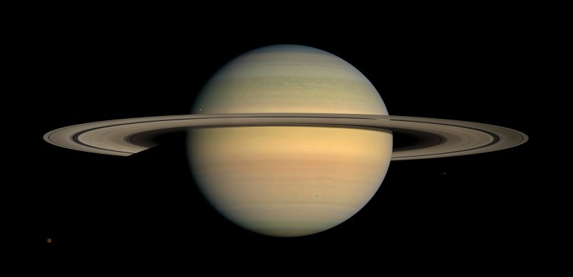 As Saturn advanced in its orbit toward equinox and the sun gradually moved northward on the planet, the motion of Saturn's ring shadows and the changing colors of its atmosphere continued to transform the face of Saturn as seen by Cassini in this image from the mission's fourth year.Cassini has been orbiting Saturn for five Earth years as of June 30, 2009. That's about one sixth of a Saturnian year, enough time for the spacecraft to have observed seasonal changes in the planet, its moons and sunlight's angle on the dramatic rings.This captivating natural color view was created from images collected shortly after Cassini began its extended Equinox Mission in July 2008. The mosaic combines 30 images-10 each of red, green and blue light-taken over the course of approximately two hours as Cassini panned its wide-angle camera across the entire planet and ring system on July 23, 2008, from a southerly elevation of 6 degrees.Six moons complete this constructed panorama (see the full-size image): Titan (3,200 miles, or 5,150 kilometers, across), Janus (111 miles, or 179 kilometers, across), Mimas (396 kilometers, or 246 miles, across), Pandora (81 kilometers, or 50 miles, across), Epimetheus (70 miles, or 113 kilometers, across) and Enceladus (504 kilometers, or 313 miles, across).Cassini captured these images at a distance of approximately 690,000 miles (1.1 million kilometers) from Saturn and at a sun-Saturn-spacecraft, or phase, angle of 20 degrees.Image Credit: NASA/JPL/Space Science Institute