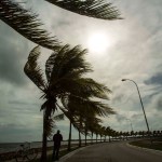 A man stands as the wind blows on the Malecon in Caibarien, central Cuba, Friday, Sept. 8, 2017. (AP Photo/Desmond Boylan)