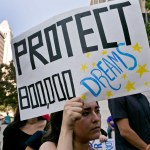 FILE - In this Sept. 1, 2017 file photo, a woman joins a rally in support of the Deferred Action for Childhood Arrivals, or DACA program, outside the Edward Roybal Federal Building in downtown Los Angeles Friday, Sept. 1, 2017. California Attorney General Xavier Becerra filed a lawsuit Monday, Sept. 11, 2017, against the Trump administration over its decision to end a program that protects young immigrants from deportation who were brought to the U.S. illegally as children or by parents who overstayed visas. (AP Photo/Damian Dovarganes, File)