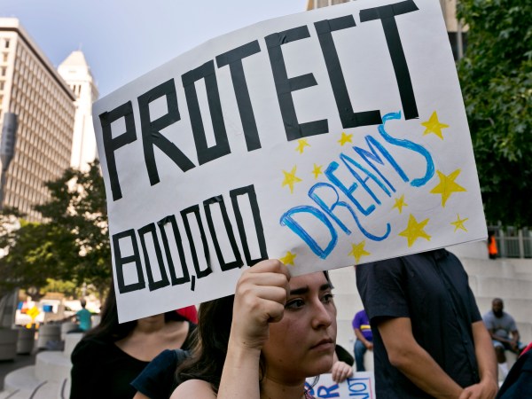 FILE - In this Sept. 1, 2017 file photo, a woman joins a rally in support of the Deferred Action for Childhood Arrivals, or DACA program, outside the Edward Roybal Federal Building in downtown Los Angeles Friday, Sept. 1, 2017. California Attorney General Xavier Becerra filed a lawsuit Monday, Sept. 11, 2017, against the Trump administration over its decision to end a program that protects young immigrants from deportation who were brought to the U.S. illegally as children or by parents who overstayed visas. (AP Photo/Damian Dovarganes, File)