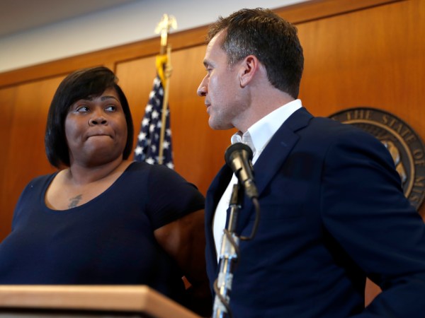 Missouri Gov. Eric Greitens, right, and Christina Wilson, the fiancée of Anthony Lamar Smith, deliver a statement in anticipation of a verdict in the trial of former St. Louis police officer Jason Stockley Thursday, Sept. 14, 2017, in St. Louis. Stockley is accused in the 2011 killing of Lamar Smith following a high-speed chase. (AP Photo/Jeff Roberson)