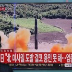 A woman watches a TV screen showing a file footage of North Korea's missile launch, at the Seoul Railway Station in Seoul, South Korea, Friday, Sept. 15, 2017. South Korea's military said North Korea fired an unidentified missile Friday from its capital Pyongyang that flew over Japan before landing in the northern Pacific Ocean. The signs read "Japan protests North Korea's missile launch" (AP Photo/Ahn Young-joon)
