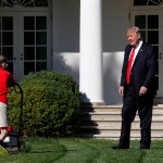 Frank "FX" Giaccio, 11, of Falls Church, Va., is surprised by President Donald Trump, Friday, Sept. 15, 2017, as he mows the lawn of the Rose Garden at the White House in Washington. The 11-year-old was focused on the job at hand and didn't notice the president until he was right next to him. (AP Photo/Jacquelyn Martin)