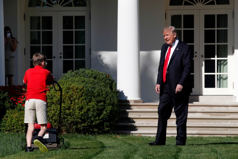 Frank "FX" Giaccio, 11, of Falls Church, Va., is surprised by President Donald Trump, Friday, Sept. 15, 2017, as he mows the lawn of the Rose Garden at the White House in Washington. The 11-year-old was focused on the job at hand and didn't notice the president until he was right next to him. (AP Photo/Jacquelyn Martin)