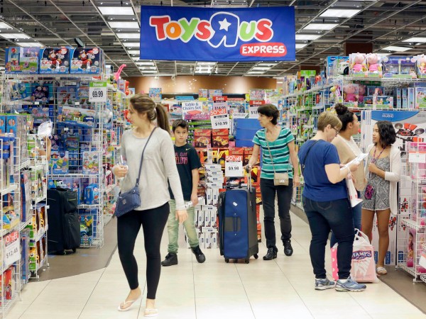 Shoppers shop in a Toys R Us store on Black Friday, Nov. 25, 2016, in Miami. Stores open their doors Friday for what is still one of the busiest days of the year, even as the start of the holiday season edges ever earlier. (AP Photo/Alan Diaz)