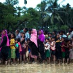 Rohingya Muslims, who crossed over recently from Myanmar into Bangladesh, stand in a queue to receive food being distributed near Balukhali refugee camp in Cox's Bazar, Bangladesh, Tuesday, Sept. 19, 2017. More than 500,000 Rohingya Muslims have fled to neighboring Bangladesh in the past year, most of them in the last three weeks, after security forces and allied mobs retaliated  to a series of attacks by Muslim militants last month by burning down thousands of Rohingya homes in the predominantly Buddhist nation. (AP Photo/Bernat Armangue)
