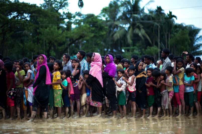 Rohingya Muslims, who crossed over recently from Myanmar into Bangladesh, stand in a queue to receive food being distributed near Balukhali refugee camp in Cox's Bazar, Bangladesh, Tuesday, Sept. 19, 2017. More than 500,000 Rohingya Muslims have fled to neighboring Bangladesh in the past year, most of them in the last three weeks, after security forces and allied mobs retaliated  to a series of attacks by Muslim militants last month by burning down thousands of Rohingya homes in the predominantly Buddhist nation. (AP Photo/Bernat Armangue)