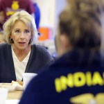 U.S. Secretary of Education Betsy DeVos talks with Gracie Johnsonduring a hog roast before a high school football game between Eastern Hancock and Knightstown, Friday, Sept. 15, 2017, in Charlottesville, Ind. (AP Photo/Darron Cummings)
