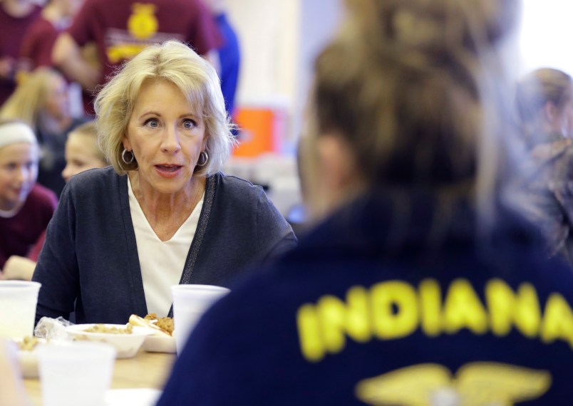 U.S. Secretary of Education Betsy DeVos talks with Gracie Johnsonduring a hog roast before a high school football game between Eastern Hancock and Knightstown, Friday, Sept. 15, 2017, in Charlottesville, Ind. (AP Photo/Darron Cummings)