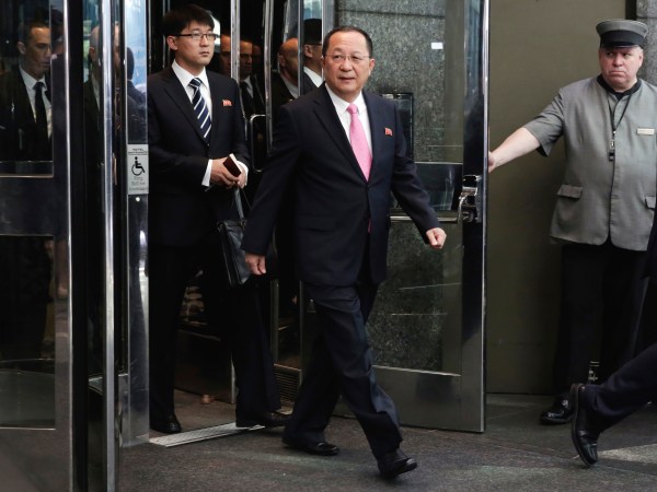 North Korea's Foreign Minister Ri Yong Ho, center, followed by his interpreter, left, walks to the microphones to speak outside the U.N. Plaza Hotel, in New York, Monday, Sept. 25, 2017. (AP Photo/Richard Drew)