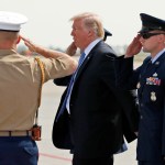 President Donald Trump is saluted as he steps off Air Force One, Wednesday, Sept. 27, 2017, in Indianapolis, Ind. (AP Photo/Alex Brandon)