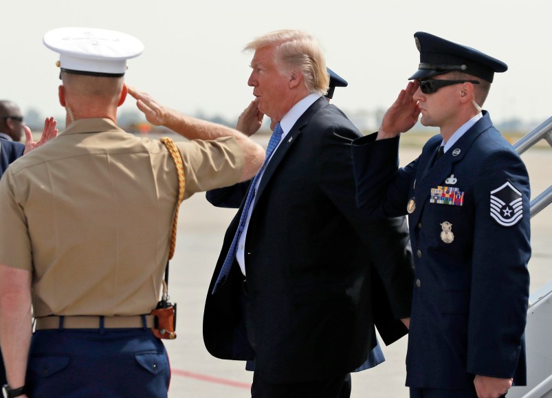 President Donald Trump is saluted as he steps off Air Force One, Wednesday, Sept. 27, 2017, in Indianapolis, Ind. (AP Photo/Alex Brandon)