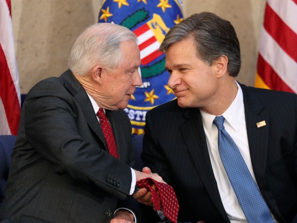 FBI Director Christopher A. Wray is welcomed at a ceremony at the FBI Building, Thursday, Sept. 28, 2017, in Washington. Also in attendance is Attorney General Jeff Sessions. (AP Photo/Andrew Harnik)