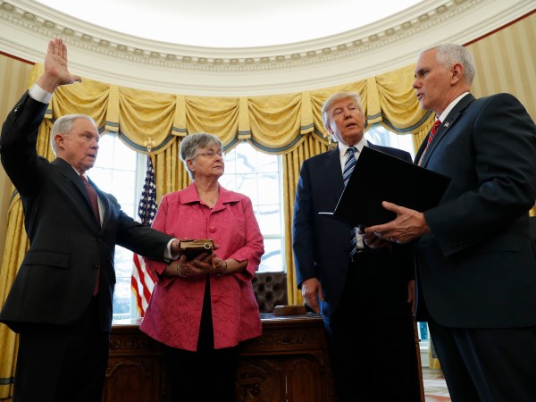 President Donald Trump watches as Vice President Mike Pence administers the oath of office to Attorney General Jeff Sessions, accompanied by his wife Mary, Thursday, Feb. 9, 2017, in the Oval Office of the White House in Washington. (AP Photo/Pablo Martinez Monsivais)