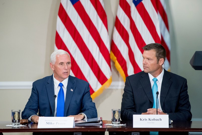 Vice President Mike Pence, left, accompanied by Vice-Char Kansas Secretary of State Kris Kobach, right, speaks during the first meeting of the Presidential Advisory Commission on Election Integrity at the Eisenhower Executive Office Building on the White House complex in Washington, Wednesday, July 19, 2017. (AP Photo/Andrew Harnik)