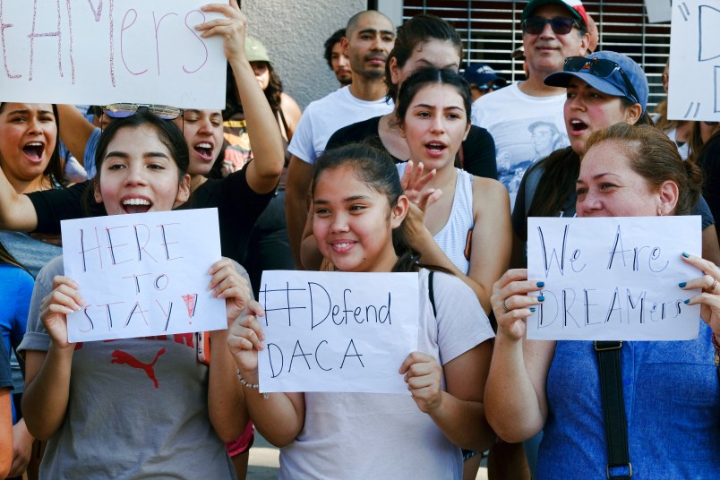 Supporters of the Deferred Action for Childhood Arrivals, or DACA chant slogans and holds signs while joining a Labor Day rally in downtown Los Angeles on Monday, Sept. 4, 2017. (AP Photo/Richard Vogel)