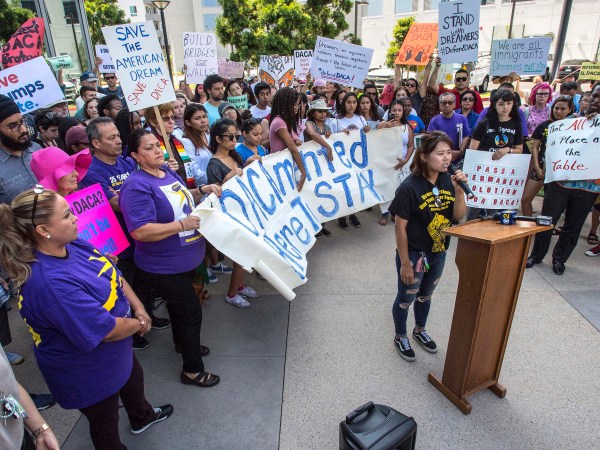 Minjung Park, a student at UC Irvine, speaks to over 100 supporters of the Deferred Action for Childhood Arrivals program, DACA, as they carry signs in protest of the Trump administration formally announcing the end of DACA, outside the office of Congresswoman Mimi Walters, near the intersection of Michelson Drive and Jamboree Road in Irvine, on Tuesday, September 5, 2017. (Photo by Mark Rightmire, Orange County Register/SCNG)