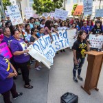 Minjung Park, a student at UC Irvine, speaks to over 100 supporters of the Deferred Action for Childhood Arrivals program, DACA, as they carry signs in protest of the Trump administration formally announcing the end of DACA, outside the office of Congresswoman Mimi Walters, near the intersection of Michelson Drive and Jamboree Road in Irvine, on Tuesday, September 5, 2017. (Photo by Mark Rightmire, Orange County Register/SCNG)