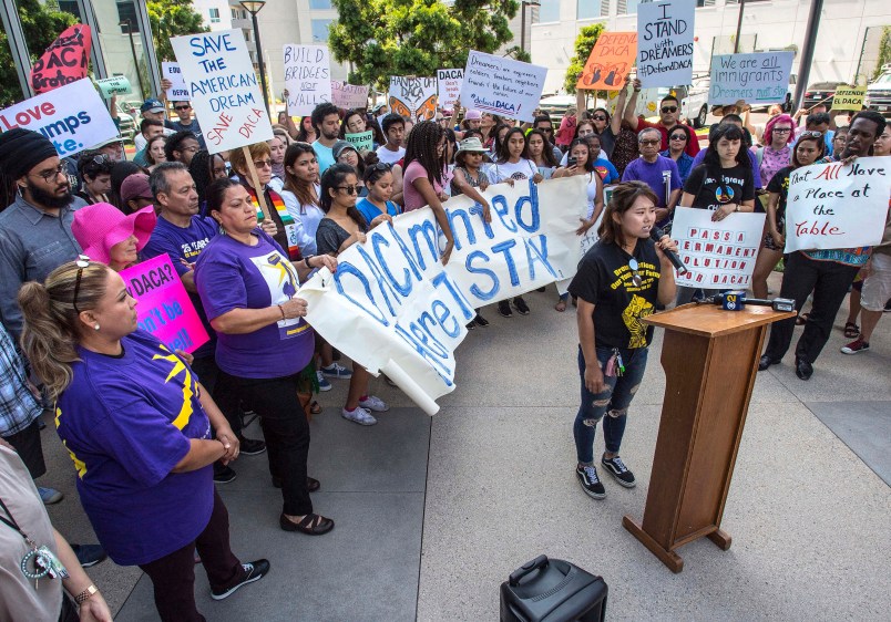 Minjung Park, a student at UC Irvine, speaks to over 100 supporters of the Deferred Action for Childhood Arrivals program, DACA, as they carry signs in protest of the Trump administration formally announcing the end of DACA, outside the office of Congresswoman Mimi Walters, near the intersection of Michelson Drive and Jamboree Road in Irvine, on Tuesday, September 5, 2017. (Photo by Mark Rightmire, Orange County Register/SCNG)