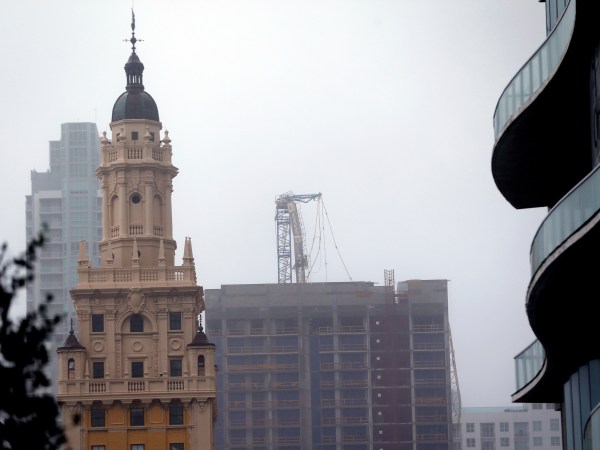 A crane atop a building under construction in downtown, center, is shown after it collapsed as Hurricane Irma passes by, Sunday, Sept. 10, 2017, in Miami. (AP Photo/Wilfredo Lee)