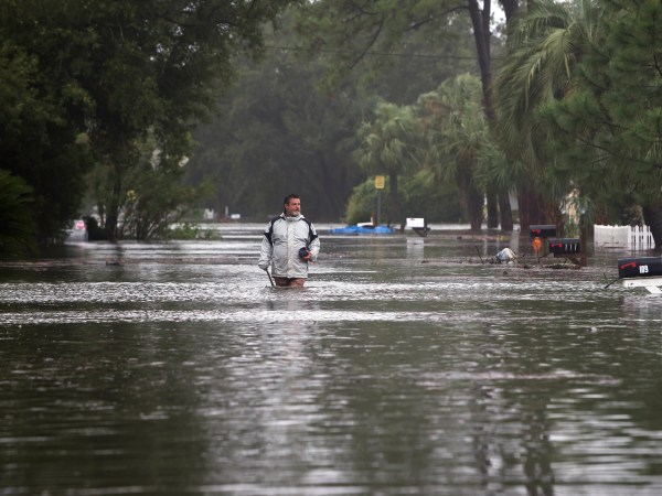 Joey Spalding walks back to his truck down the street where he lives, Monday, Sept., 11, 2017, on Tybee Island, Ga. Spalding just finished repairing his house from nine inches of water after Hurricane Matthew past the island last year. He said the Tropical Storm Irma brought three feet of storm surge into his living room today.  (AP Photo/Stephen B. Morton)