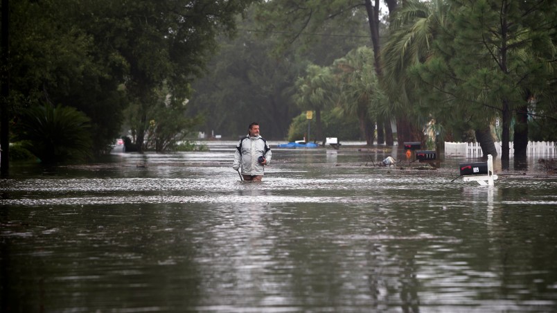 Joey Spalding walks back to his truck down the street where he lives, Monday, Sept., 11, 2017, on Tybee Island, Ga. Spalding just finished repairing his house from nine inches of water after Hurricane Matthew past the island last year. He said the Tropical Storm Irma brought three feet of storm surge into his living room today.  (AP Photo/Stephen B. Morton)