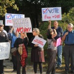 Protesters gather on Tuesday, Sept. 12, 2017, at Saint Anselm College in Manchester, New Hampshire, ahead of a  day-long meeting of the Trump administration’s election integrity commission. They argue the commission, which is tasked with investigating voter fraud, is a sham. Signs reading “Vote Free or Die” played off New Hampshire’s motto: “Live Free or Die.” (AP Photo/Holly Ramer).