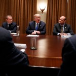Rep. Josh Gottheimer, D-N.J., left, and Rep. Tom Reed, R-N.Y., right, listen as President Donald Trump speaks during a meeting with a bipartisan group of lawmakers in the Cabinet Room of the White House, Wednesday, Sept. 13, 2017, in Washington. (AP Photo/Evan Vucci)
