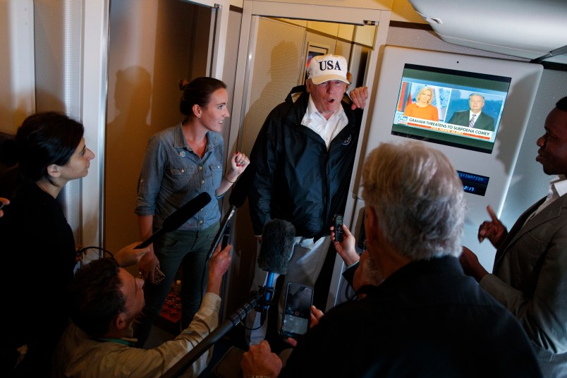 President Donald Trump talks with reporters aboard Air Force One, Thursday, Sept. 14, 2017, en route to Washington. (AP Photo/Evan Vucci)