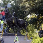 Workers prepare for the removal of a statue of Robert E. Lee at a public park in Dallas, Thursday, Sept. 14, 2017. (AP Photo/LM Otero)