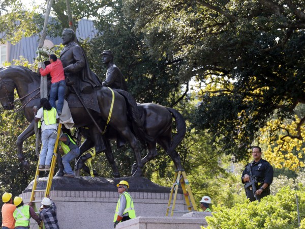 Workers prepare for the removal of a statue of Robert E. Lee at a public park in Dallas, Thursday, Sept. 14, 2017. (AP Photo/LM Otero)