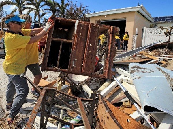 Maria Stotts, and Heather Mueller, volunteers from the Church of Jesus Christ of Latter-Day Saints, clear debris from a Monroe County sheriff's deputy home damaged by a six-foot storm surge at his home, far West in Big Pine Key. Residents were allowed to return to their homes in the Keys today a week after Hurricane Irma struck the Florida Keys.