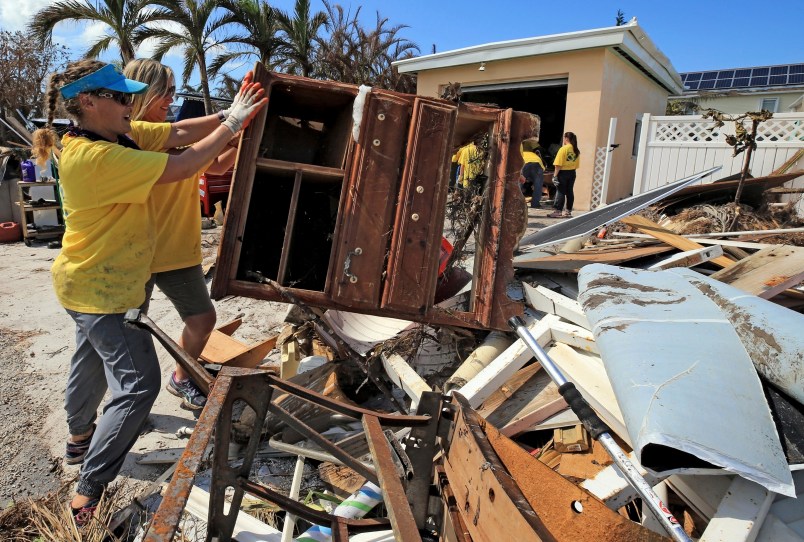 Maria Stotts, and Heather Mueller, volunteers from the Church of Jesus Christ of Latter-Day Saints, clear debris from a Monroe County sheriff's deputy home damaged by a six-foot storm surge at his home, far West in Big Pine Key. Residents were allowed to return to their homes in the Keys today a week after Hurricane Irma struck the Florida Keys.
