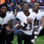 Baltimore Ravens strong safety Tony Jefferson (23) and Baltimore Ravens outside linebacker Matt Judon, left, kneel down with teammates during the playing of the U.S. national anthem before an NFL football game against the Jacksonville Jaguars at Wembley Stadium in London, Sunday Sept. 24, 2017. (AP Photo/Matt Dunham)