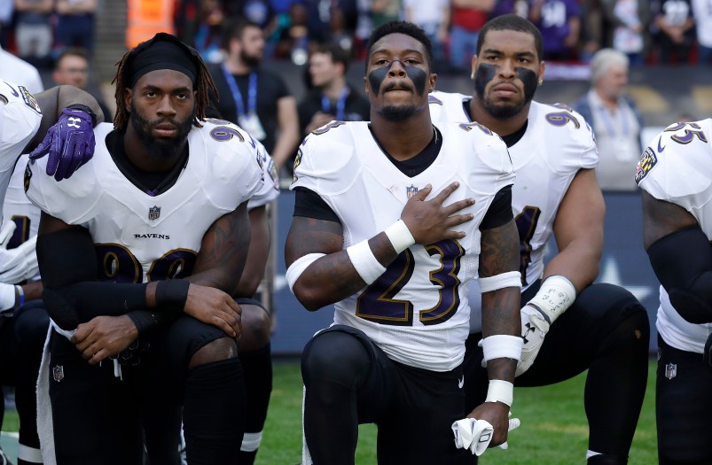 Baltimore Ravens strong safety Tony Jefferson (23) and Baltimore Ravens outside linebacker Matt Judon, left, kneel down with teammates during the playing of the U.S. national anthem before an NFL football game against the Jacksonville Jaguars at Wembley Stadium in London, Sunday Sept. 24, 2017. (AP Photo/Matt Dunham)