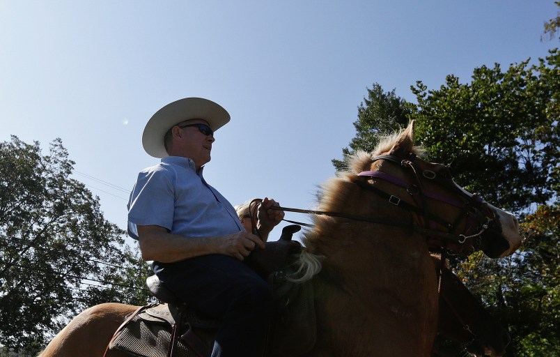 Former Alabama Chief Justice and U.S. Senate candidate Roy Moore, rides in on a horse to vote a the Gallant Volunteer Fire Department, during the Alabama Senate race, Tuesday, Sept. 26, 2017, in Gallant, Ala. (AP Photo/Brynn Anderson)