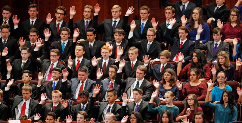 Members of a youth choir raise their hands during a sustaining vote during the afternoon session of the two-day Mormon church conference Saturday, Sept. 30, 2017, in Salt Lake City.  (AP Photo/Rick Bowmer)