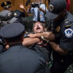 Activists opposed to the  GOP's Graham-Cassidy health care repeal bill, many with disabilities, are removed by U.S. Capitol Police after disrupting a Senate Finance Committee hearing on the last-ditch GOP push to overhaul the nation's health care system, on Capitol Hill in Washington, Monday, Sept. 25, 2017. (AP Photo/J. Scott Applewhite)