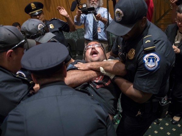 Activists opposed to the  GOP's Graham-Cassidy health care repeal bill, many with disabilities, are removed by U.S. Capitol Police after disrupting a Senate Finance Committee hearing on the last-ditch GOP push to overhaul the nation's health care system, on Capitol Hill in Washington, Monday, Sept. 25, 2017. (AP Photo/J. Scott Applewhite)